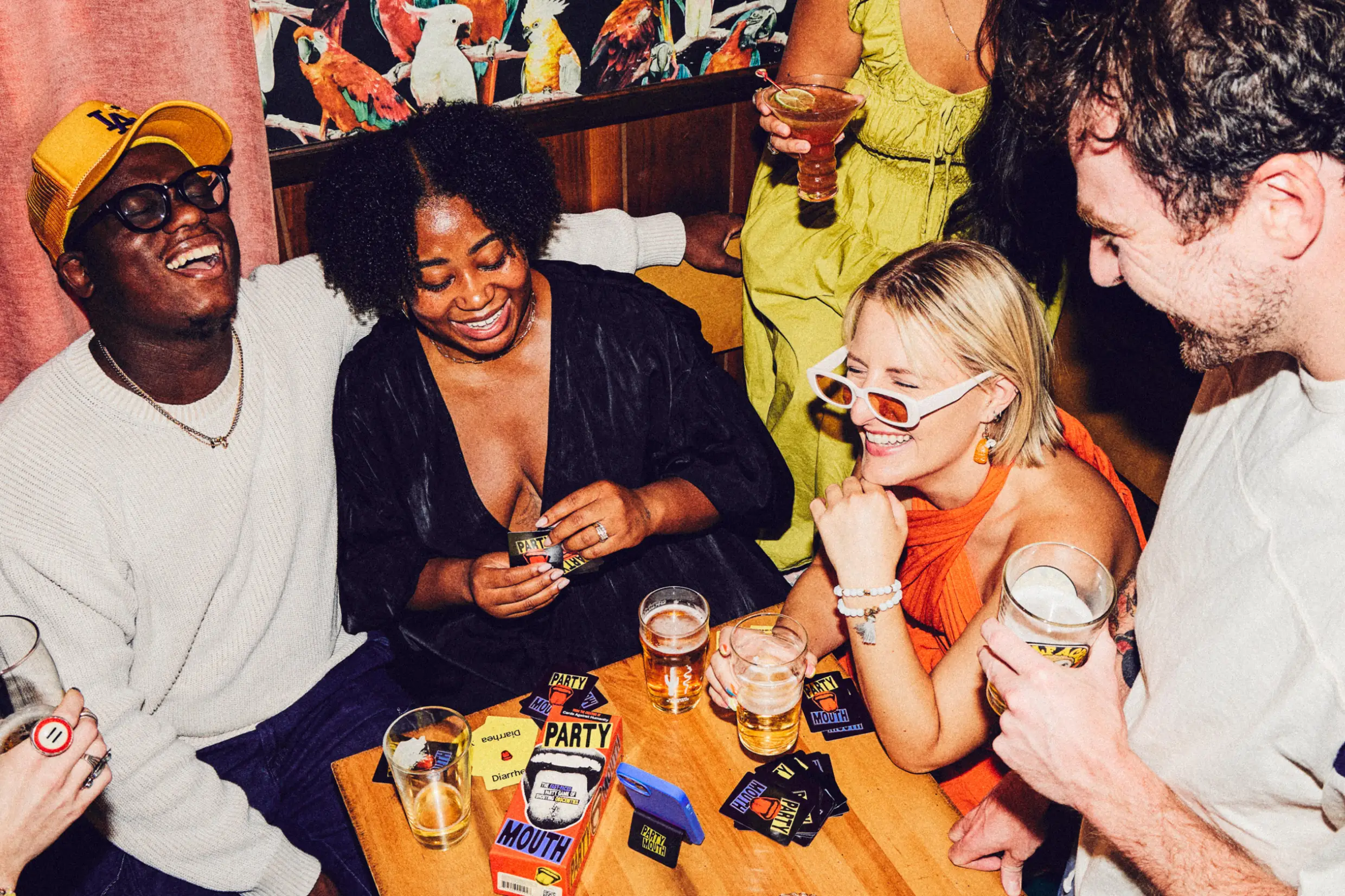 people laughing, drinking, and playing Party Mouth