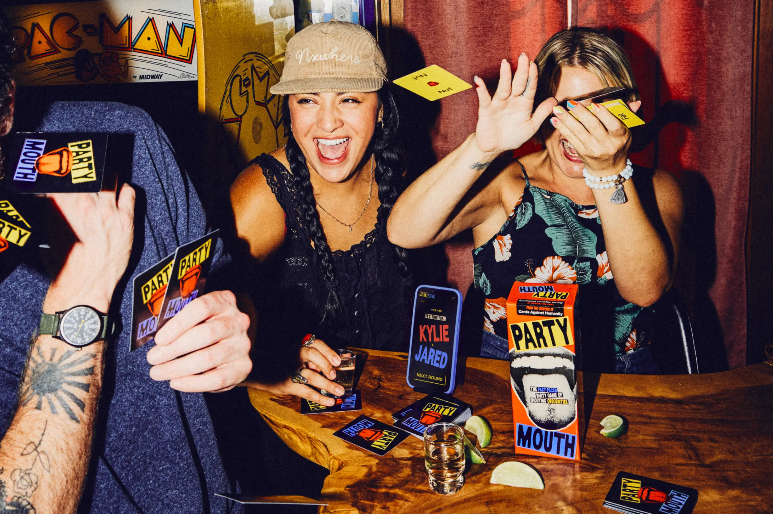 women laughing and throwing cards