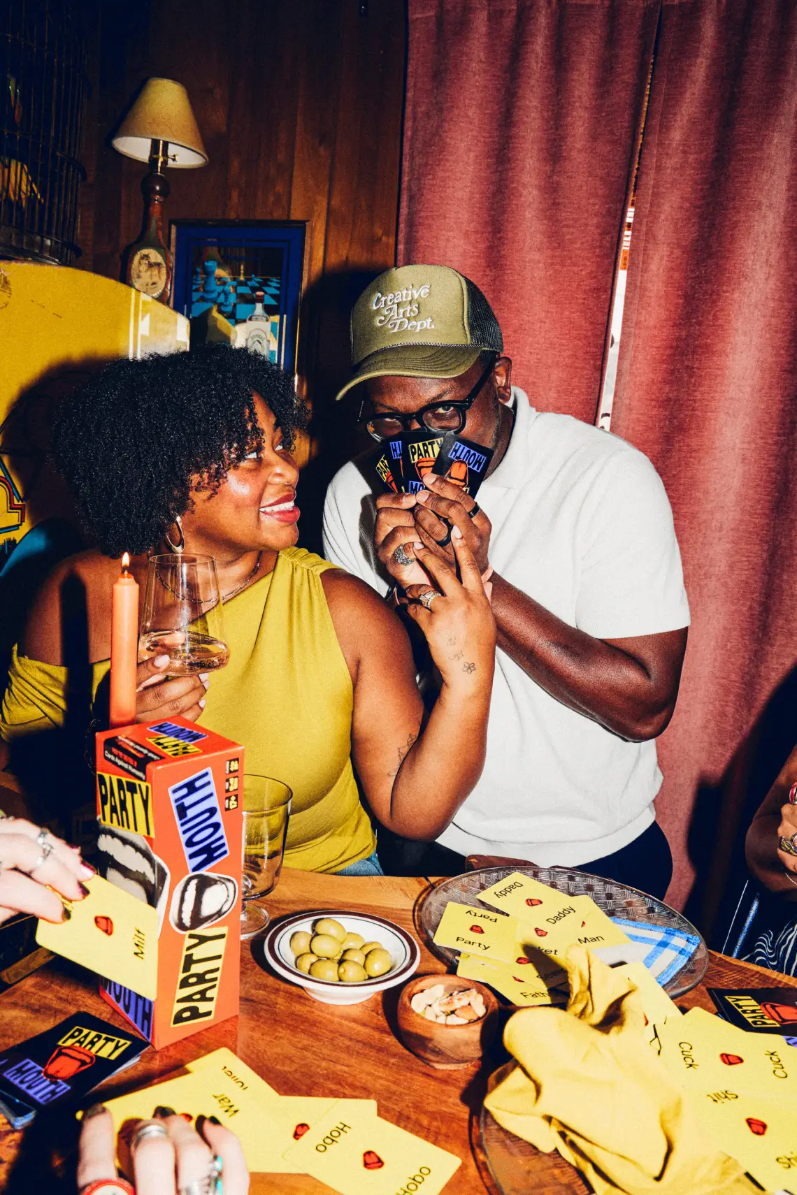 man covering his face with Party Mouth cards