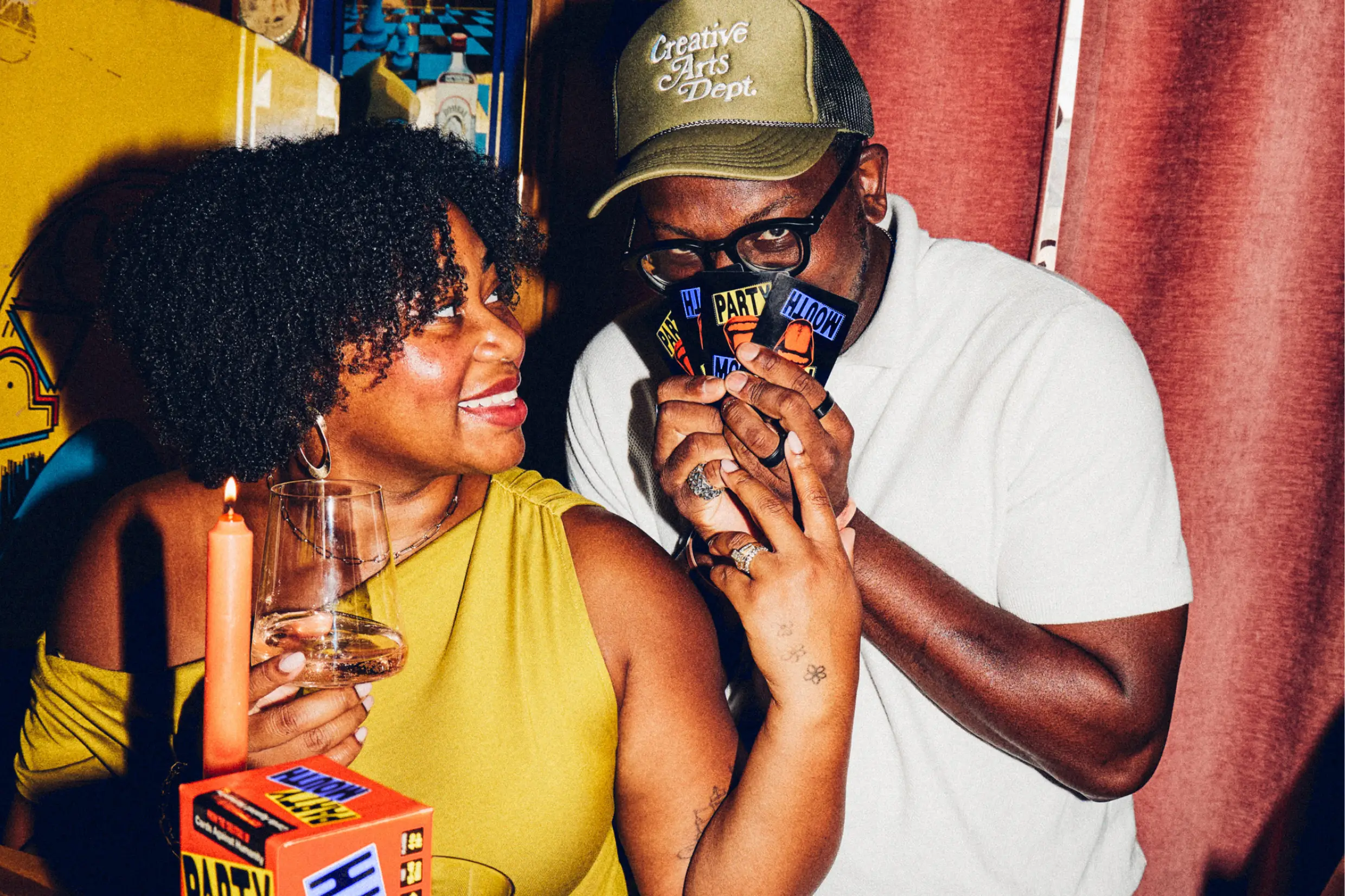 man covering his face with Party Mouth cards